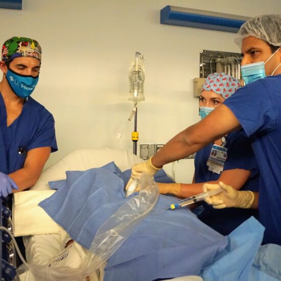 Medical students in scrubs and gloves