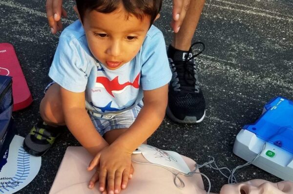 Child performing CPR