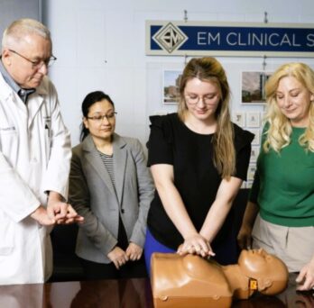 Physicians demonstrating CPR on mannikin
                  