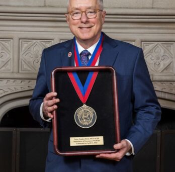 Portrait of TVH holding the award
                  