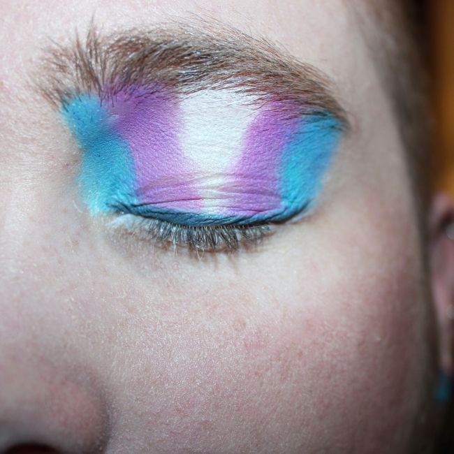 Closeup of eye makeup painted to look like trans pride flag