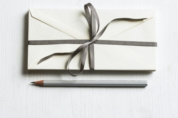 Envelope with ribbon and pencil