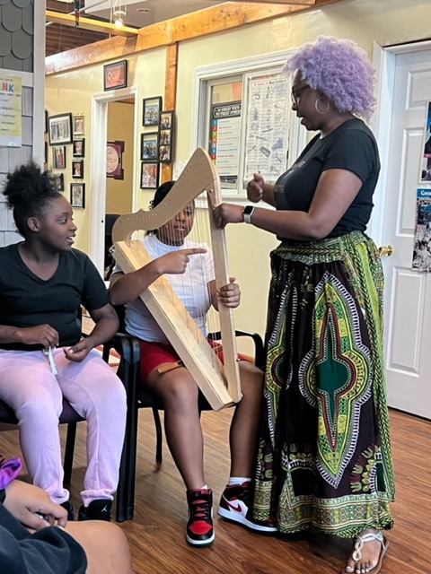 An African American women teaching a kid