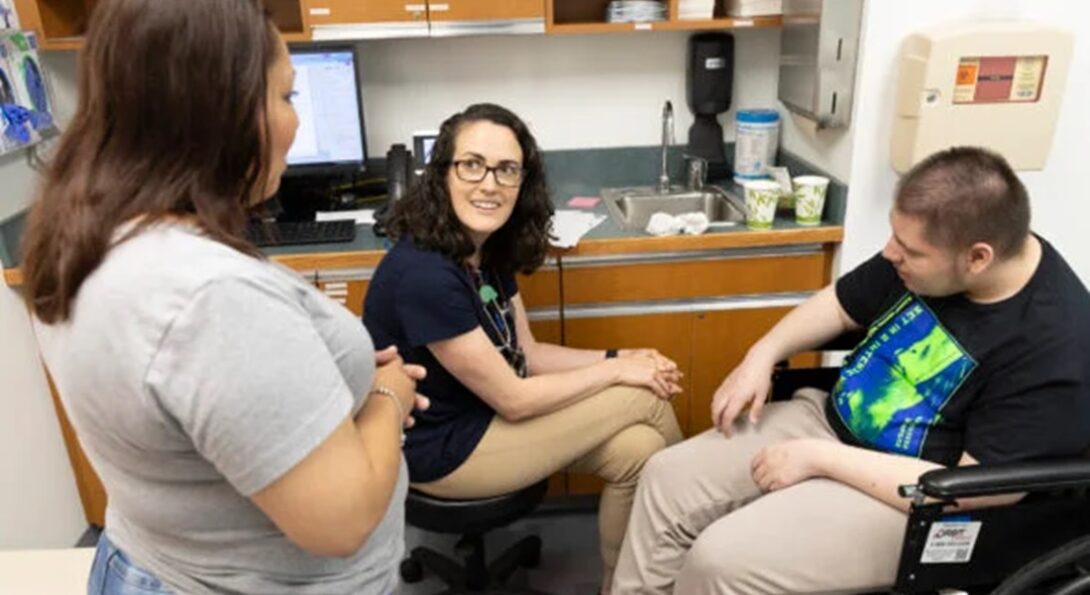 Dr. Erin Hickey, center, talks with patient Isaiah Menchaca and his mom, Josephine Alvarez, during a visit to the UI Health Lifespan Disability Clinic. (Photo: Jenny Fontaine/UIC)