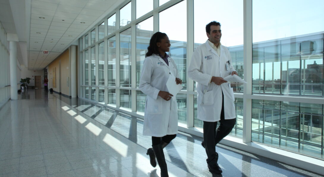 Two doctors walking down a hallway