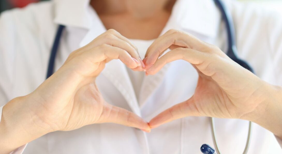 Doctor showing a heart with hands