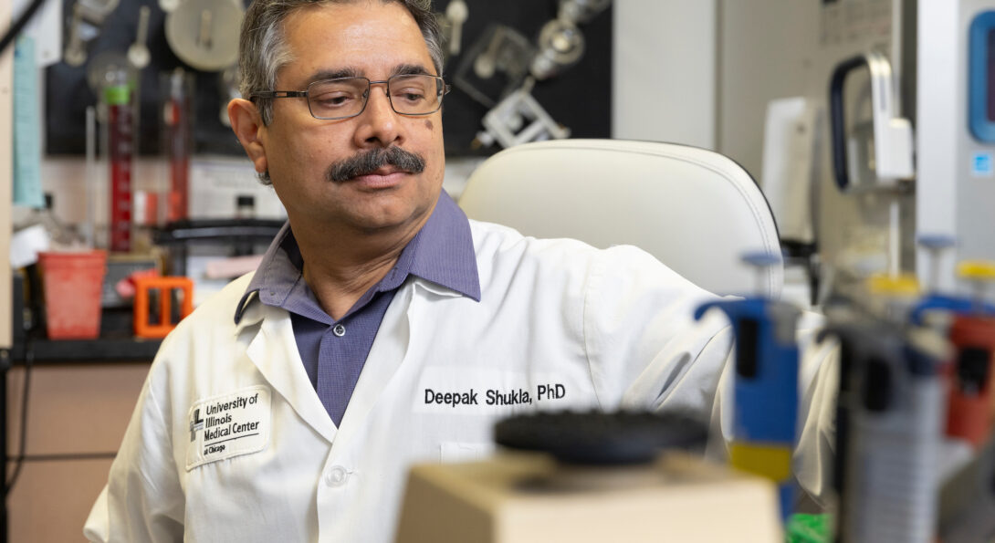Dr. Deepak Shukla sits in his research lab.