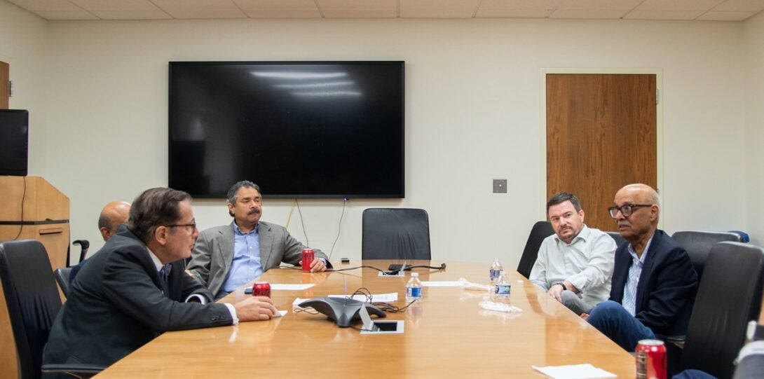 Group discussion with Vision Research Faculty/Mentors at a long meeting table.