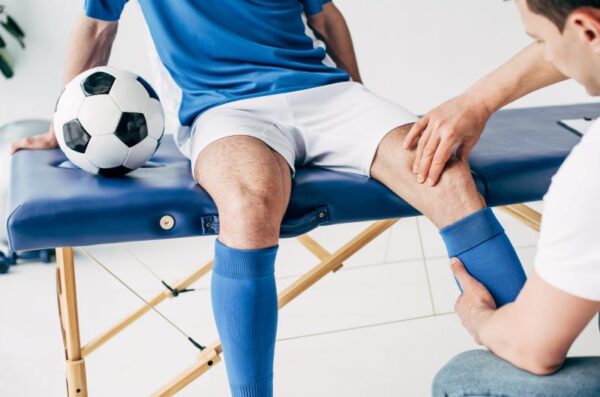 A soccer player's knee being examined