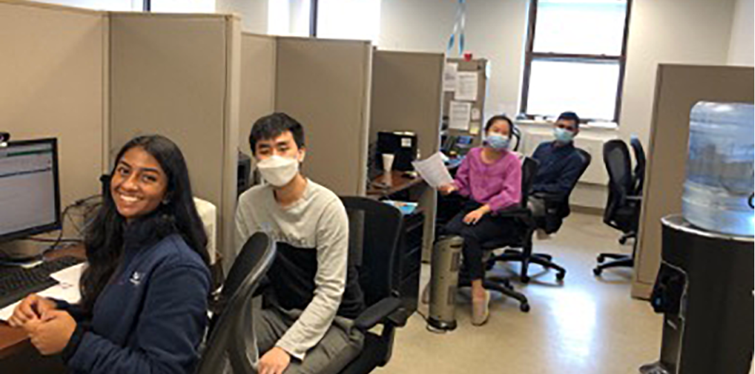 Photo of team sitting on the desk