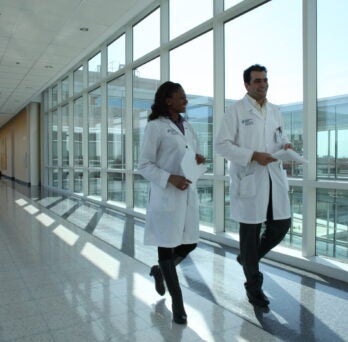 Physicians walking in corridor
                  