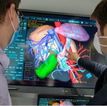 Researchers looking at computer screen 