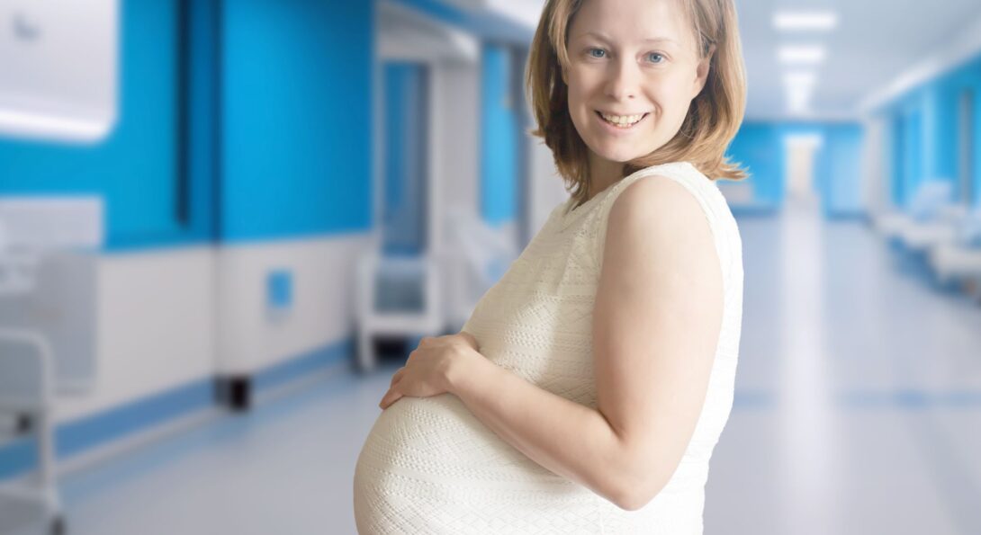 A pregnant woman in a hospital hallway