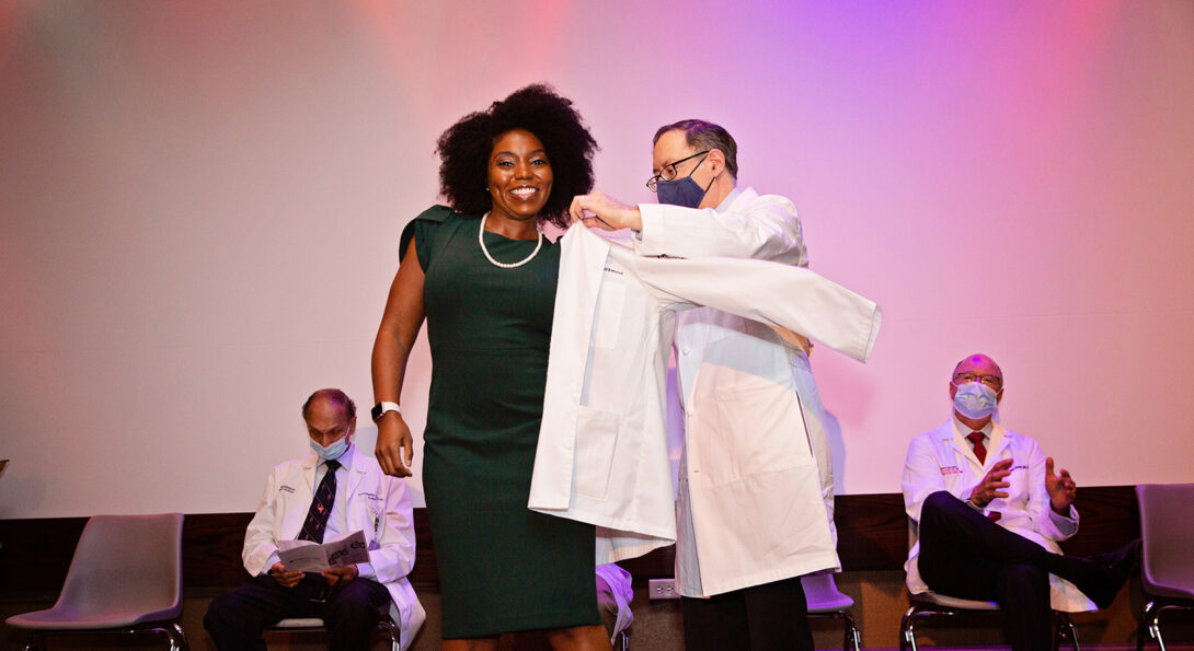 Student receiving a white coat